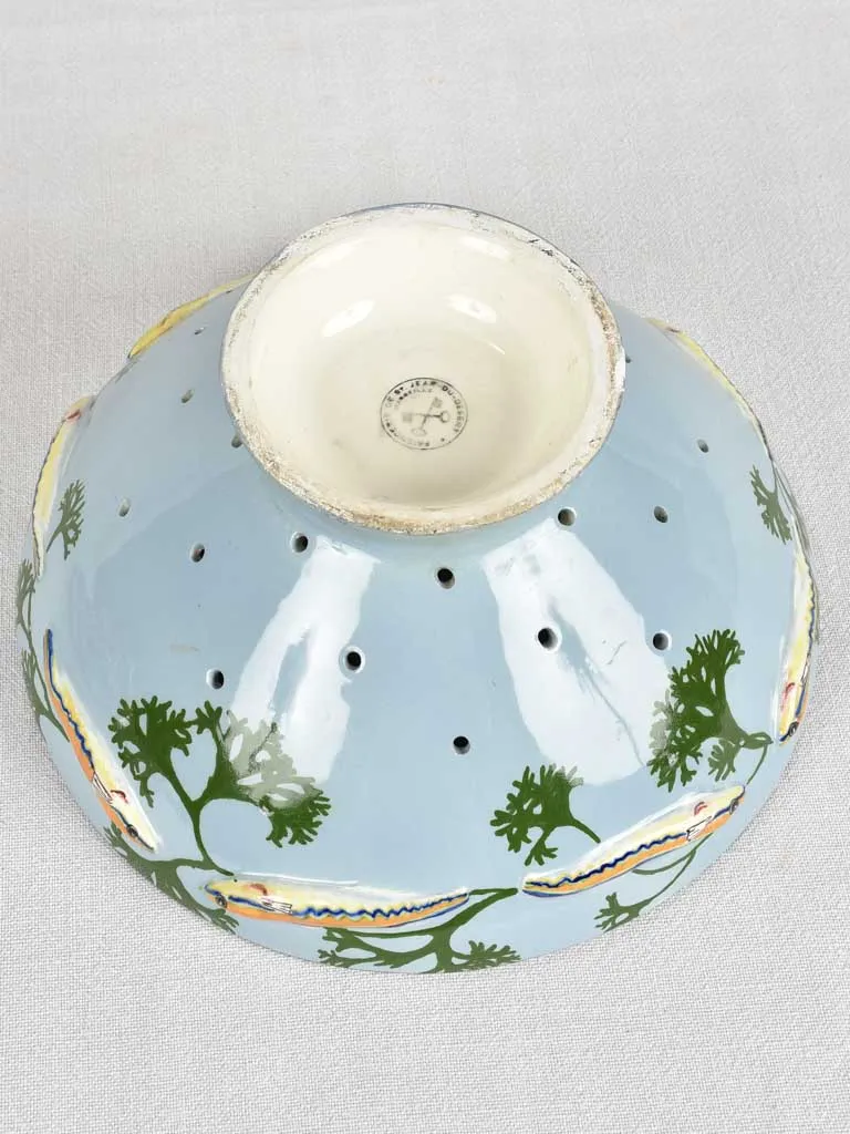 Blue strainer bowl for bouillabaisse with lobster handle
